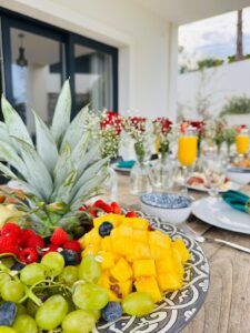 Brunch table with fresh fruit and mimosas