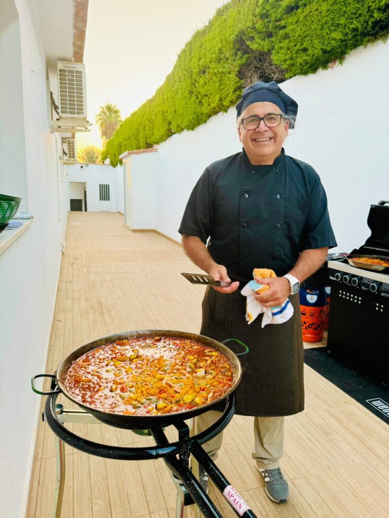 Chef cooking paella live at an event
