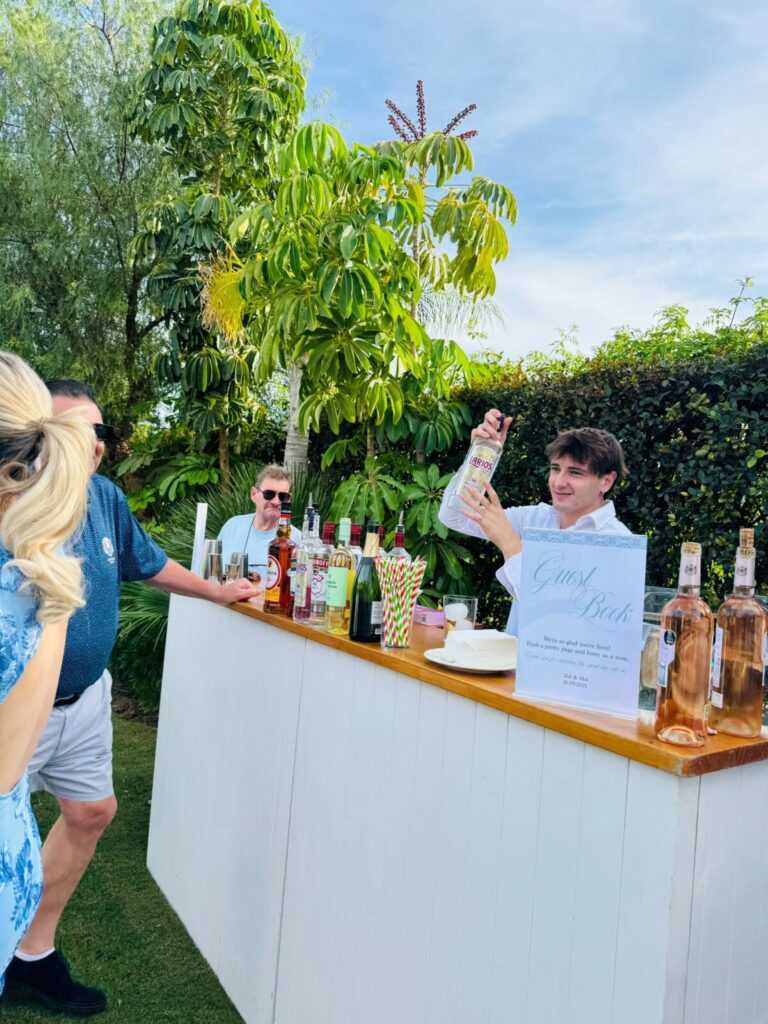 Bartender serving cocktails at a private event bar