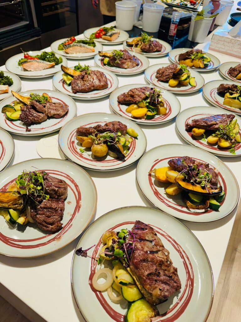 Plated main courses ready for service at a catered event