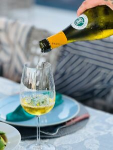 White wine being poured at a private dinner